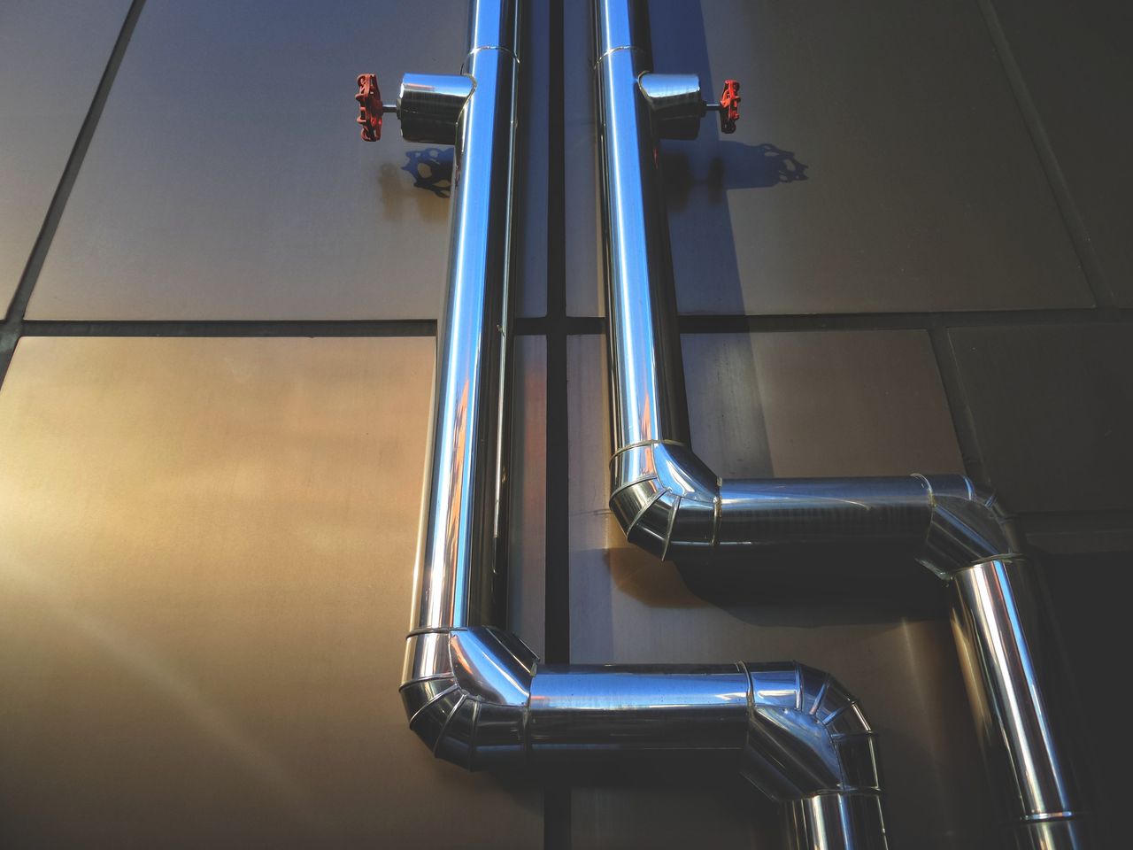 Mastering the First Impression: Your intriguing post title goes here Close-up view of industrial steel pipes with valves on a metallic background, showcasing architecture.