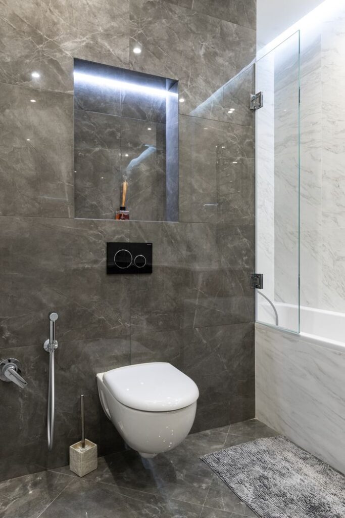 Elegant modern bathroom with marble walls and fixtures.